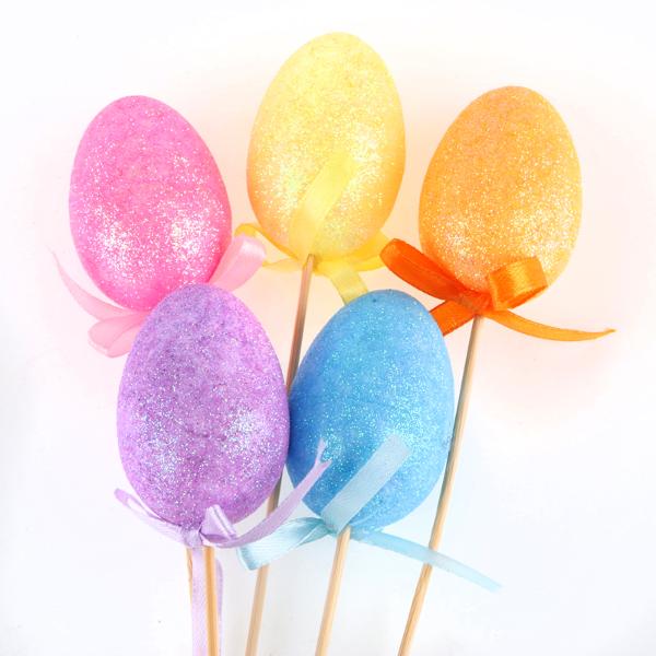 Polystyrene Egg On Pick With Glitter 5pc Total Length: 26cm (Egg - 6cm x 4cm) Blue, Yellow, Pink, Purple & Orange Per Pack